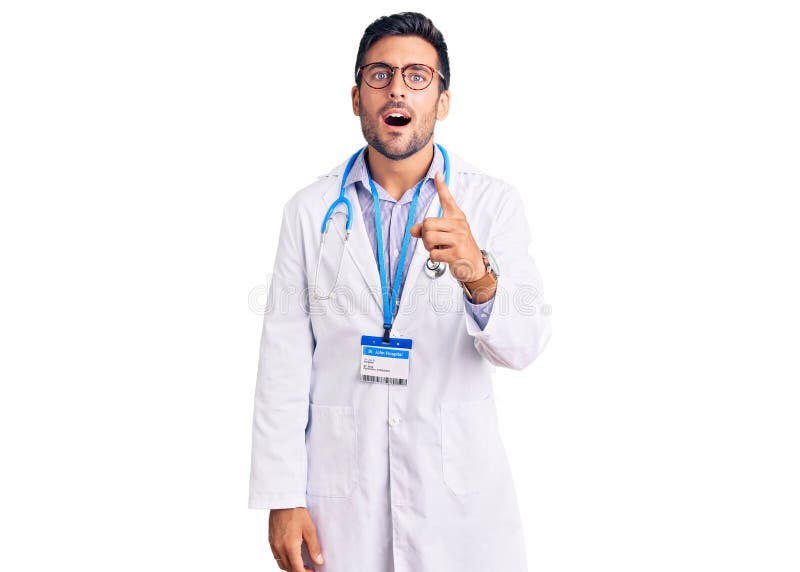 Young hispanic man wearing doctor uniform and stethoscope pointing displeased and frustrated to the camera, angry and furious with you. Young hispanic man wearing doctor uniform and stethoscope pointing displeased and frustrated to the camera, angry and furious with you