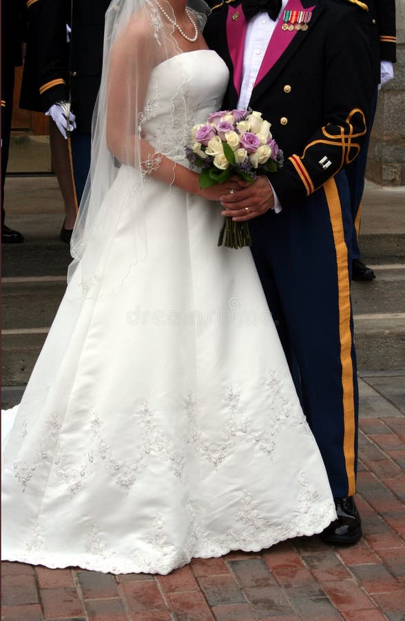 A bride and groom with the groom in his army formal military attire. A bride and groom with the groom in his army formal military attire.