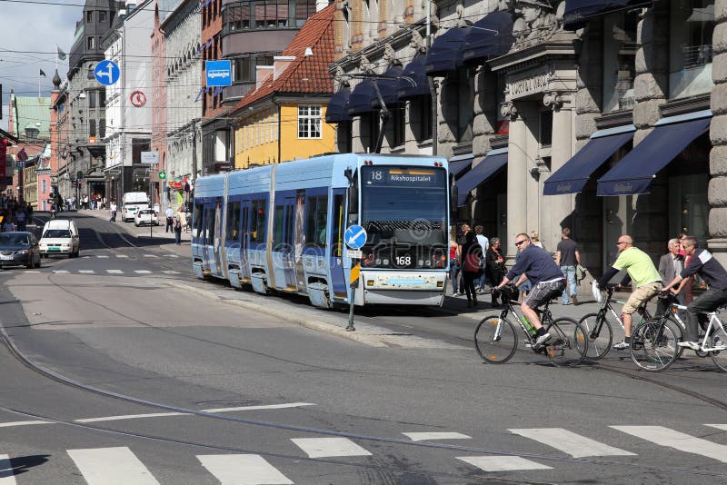 OSLO - AUGUST 21: Cyclists and public tram on August 21, 2010 in Oslo, Norway. It is reported by E24.no that in 1st half of 2009 bicycle thefts have risen 17% compared to 2008. OSLO - AUGUST 21: Cyclists and public tram on August 21, 2010 in Oslo, Norway. It is reported by E24.no that in 1st half of 2009 bicycle thefts have risen 17% compared to 2008.