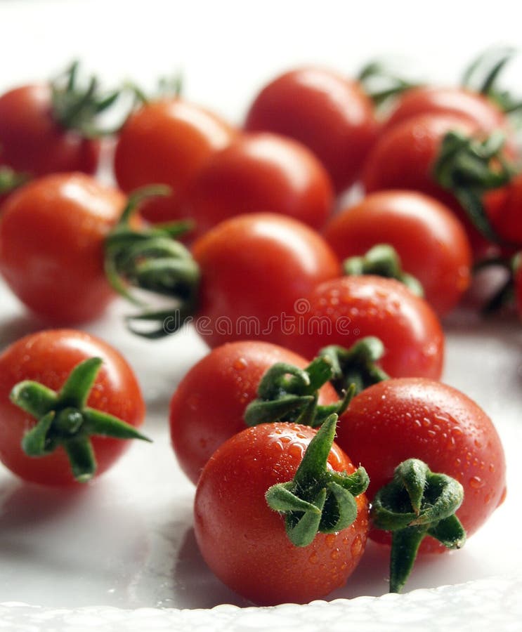 Delicious cherry tomatoes on a ehite plate. Delicious cherry tomatoes on a ehite plate