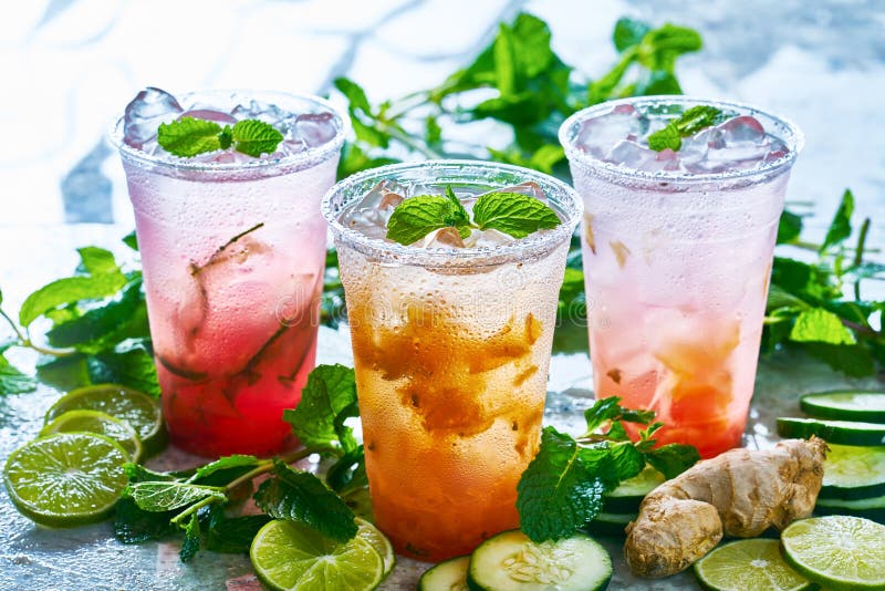 Tasty infused water with ginger, lime, cucumber and fruits shot with back lighting. Tasty infused water with ginger, lime, cucumber and fruits shot with back lighting