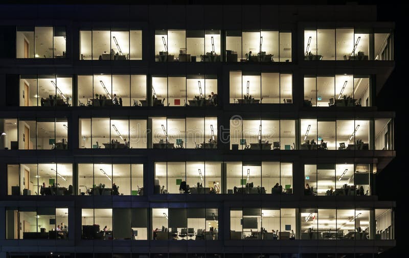 People working at night in the office block in Krakow, Poland. People working at night in the office block in Krakow, Poland