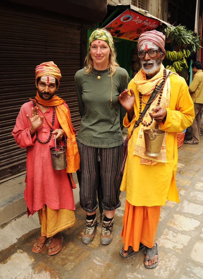 KATHMANDU, NEPAL - OCTOBER 1: Nepalese holy men pose for picture with european tourist on October 1, 2010 in Kathmandu. Photo of a hindu holy men try to get some money. KATHMANDU, NEPAL - OCTOBER 1: Nepalese holy men pose for picture with european tourist on October 1, 2010 in Kathmandu. Photo of a hindu holy men try to get some money.