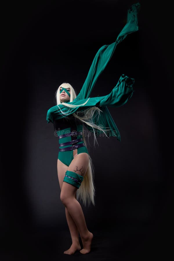 Blond girl posing in green fury cosplay costume anime character. Blond girl posing in green fury cosplay costume anime character