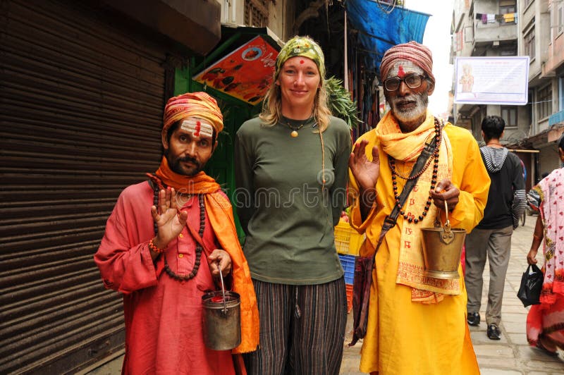 KATHMANDU, NEPAL - OCTOBER 1: Nepalese holy men pose for picture with european tourist on October 1, 2010 in Kathmandu. Photo of a hindu holy men try to get some money. KATHMANDU, NEPAL - OCTOBER 1: Nepalese holy men pose for picture with european tourist on October 1, 2010 in Kathmandu. Photo of a hindu holy men try to get some money.