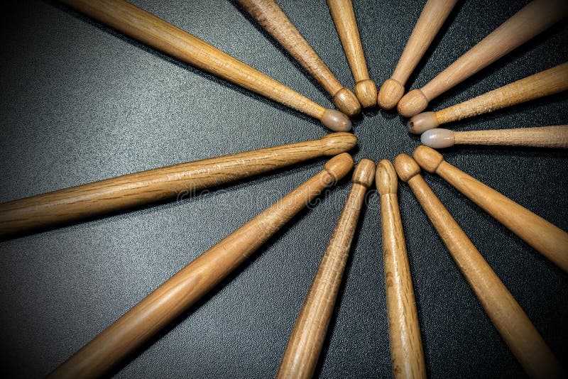 Close-up of a group of used wooden drumsticks on a dark background with copy space. Percussion instrument. Close-up of a group of used wooden drumsticks on a dark background with copy space. Percussion instrument