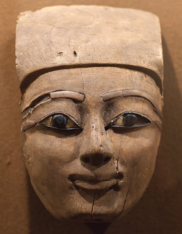 Luxor, Egypt - December 28, 2018: Wooden mummy mask of a nameless deceased that was placed over the head and upper torso of the mummy. It dates to the late Ptolemaic Period or early Roman Period circa 100 to 1 BCE. Luxor, Egypt - December 28, 2018: Wooden mummy mask of a nameless deceased that was placed over the head and upper torso of the mummy. It dates to the late Ptolemaic Period or early Roman Period circa 100 to 1 BCE