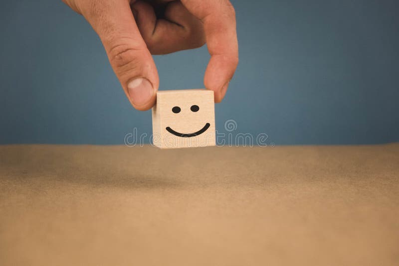 Ξύλινος κύβος και η εικόνα ενός smiley χαμόγελου που είναι προσωπικά χέρι στοκ φωτογραφίες Ξύλινος κύβος και η εικόνα ενός smiley χαμόγελου που είναι προσωπικά χέρι στοκ φωτογραφίες