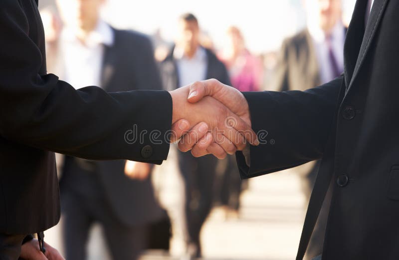Businessman and business women shaking hands in street. Businessman and business women shaking hands in street
