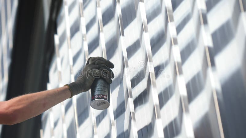 ο εργαζόμενος σχεδιάζει λευκές λωρίδες στην πρόσοψη του μαγαζιού με σπρέερ απόθεμα βίντεο