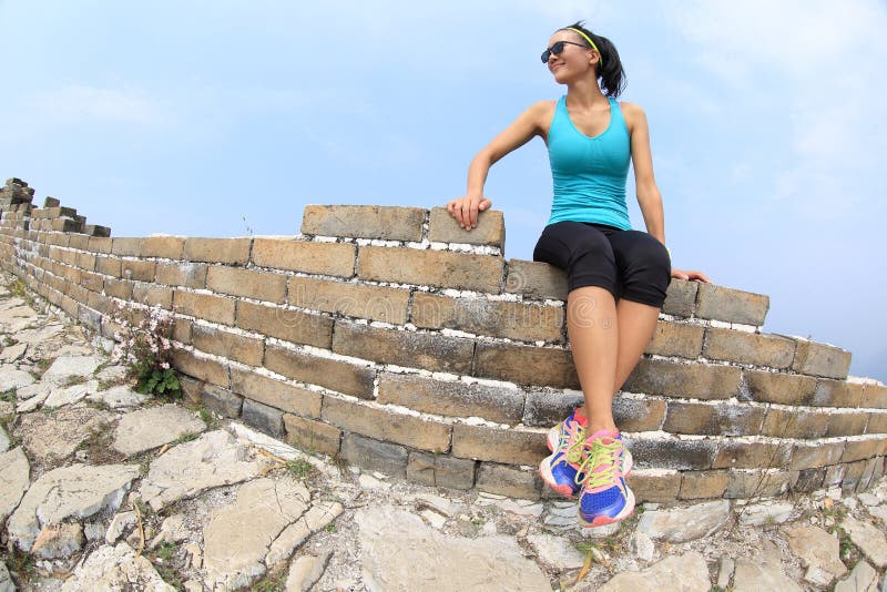 Ftiness woman runner sit on great wall. Ftiness woman runner sit on great wall