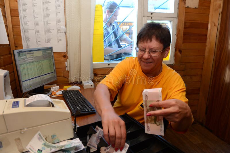 MOSCOW, RUSSIA -JULY 27, 2012: The cashier sells tickets for long-distance buses at the bus station in Moscow. MOSCOW, RUSSIA -JULY 27, 2012: The cashier sells tickets for long-distance buses at the bus station in Moscow