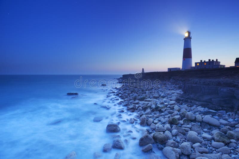 The Portland Bill Lighthouse on the Isle of Portland in Dorset, England at night. The Portland Bill Lighthouse on the Isle of Portland in Dorset, England at night.