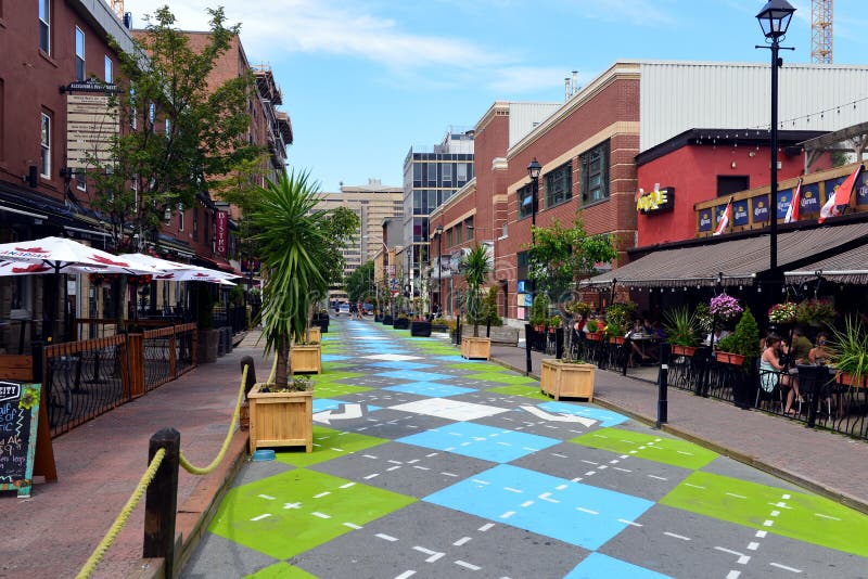 Halifax, Canada - August 3, 2015: Argyle Street in Halifax, Nova Scotia, famous for its trendy bars and restaurants, with a new Argyle paint job on the section that has been closed to traffic. Halifax, Canada - August 3, 2015: Argyle Street in Halifax, Nova Scotia, famous for its trendy bars and restaurants, with a new Argyle paint job on the section that has been closed to traffic.