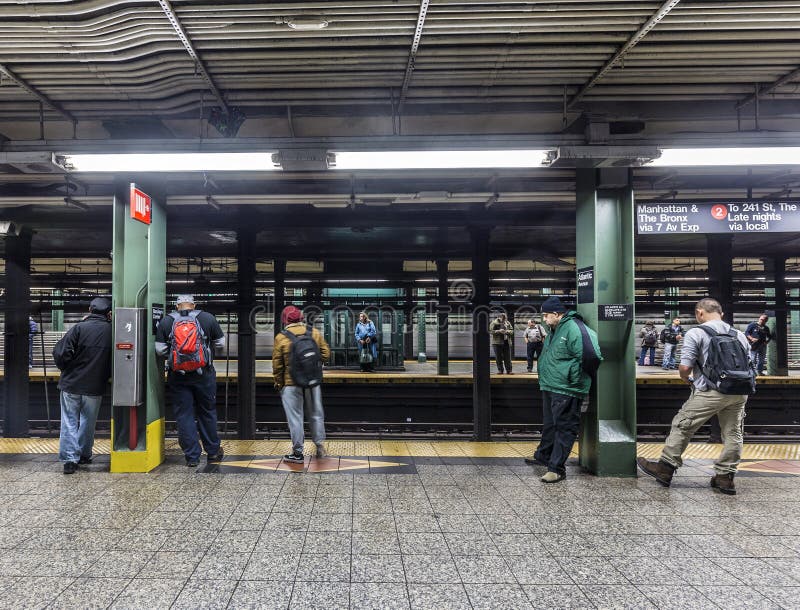 NEW YORK, USA - OCT 20, 2015: People wait at subway station Wall street in New York. With 1.75 billion annual ridership, NYC Subway is the 7th busiest metro system in the world. NEW YORK, USA - OCT 20, 2015: People wait at subway station Wall street in New York. With 1.75 billion annual ridership, NYC Subway is the 7th busiest metro system in the world.