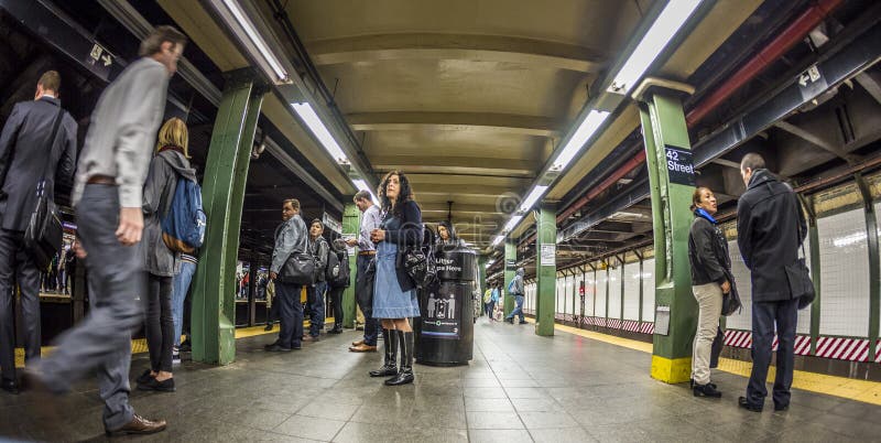 NEW YORK, USA - OCT 21 2015: People wait at subway station times square in New York. With 1.75 billion annual ridership, NYC Subway is the 7th busiest metro system in the world. NEW YORK, USA - OCT 21 2015: People wait at subway station times square in New York. With 1.75 billion annual ridership, NYC Subway is the 7th busiest metro system in the world.