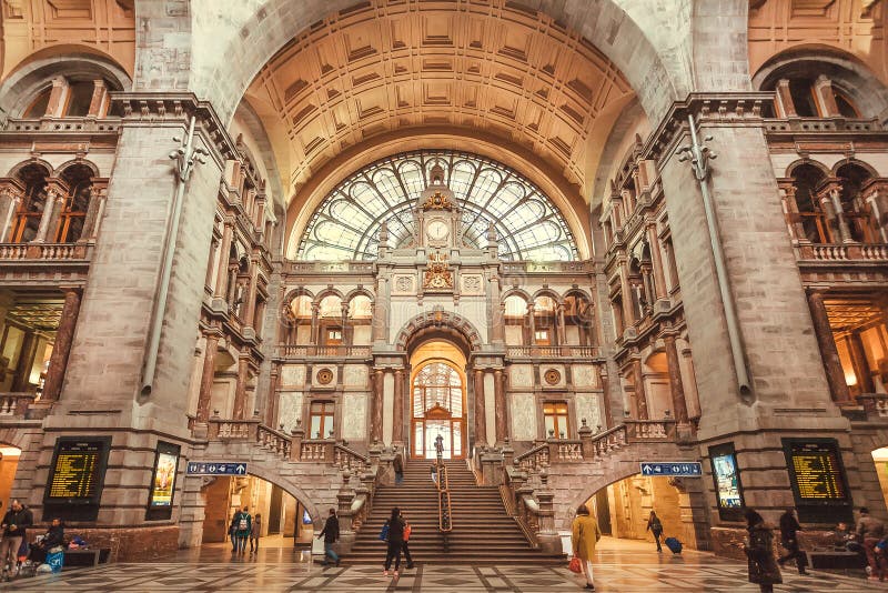 ANTWERP, BELGIUM - MAR 30: Passengers rushing for trains in the terminus building of railway station Antwerpen Centraal, constructed in 1905, on March 30, 2018. Near 1,200,000 people lives in Antwerp. ANTWERP, BELGIUM - MAR 30: Passengers rushing for trains in the terminus building of railway station Antwerpen Centraal, constructed in 1905, on March 30, 2018. Near 1,200,000 people lives in Antwerp