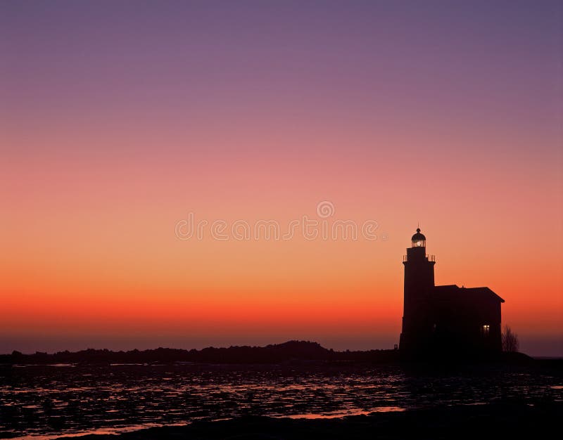 Lighthouse sillouette at sunrise the netherlands. Lighthouse sillouette at sunrise the netherlands