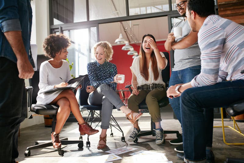 Shot of a group of young business professionals having a meeting. Diverse group of young designers smiling during a meeting at the office. Shot of a group of young business professionals having a meeting. Diverse group of young designers smiling during a meeting at the office.