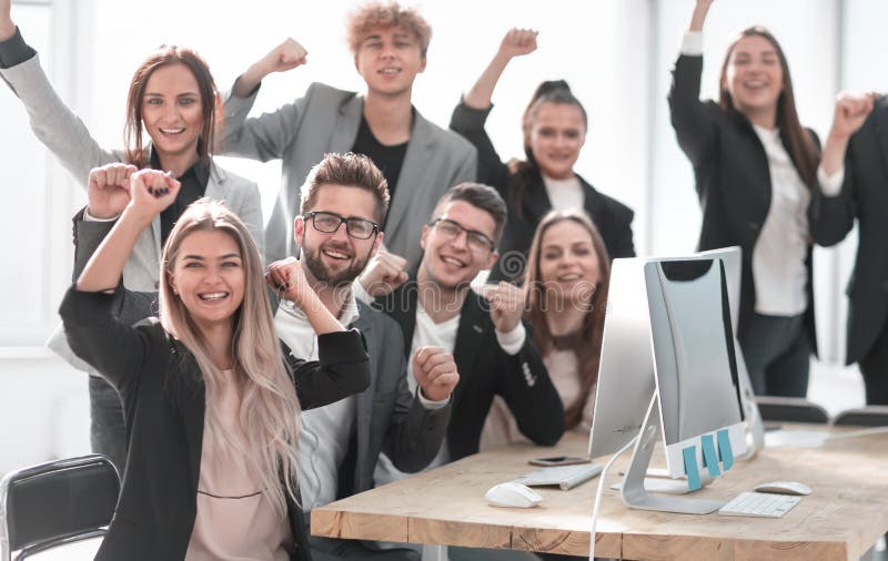 Group of young professionals sitting at an office Desk. the concept of teamwork. Group of young professionals sitting at an office Desk. the concept of teamwork