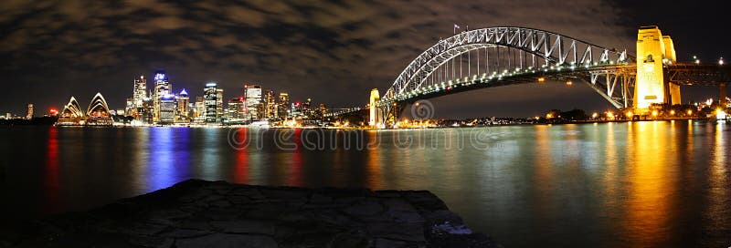 Panorama of Sydney's skyline, Opera House and Harbour Bridge at night. Panorama of Sydney's skyline, Opera House and Harbour Bridge at night