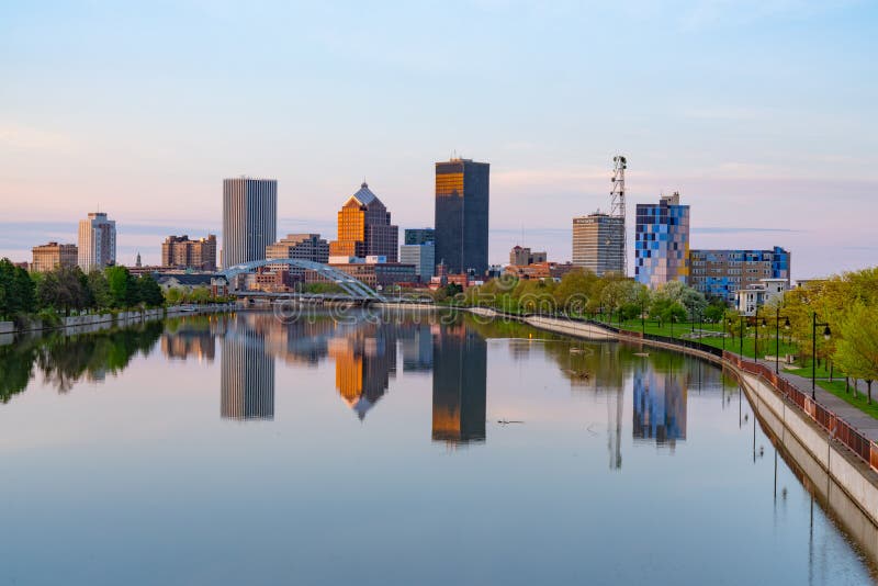 ROCHESTER, NY - MAY 14, 2018: Skyline of Rochester, New York along Genesee River at sunset. ROCHESTER, NY - MAY 14, 2018: Skyline of Rochester, New York along Genesee River at sunset