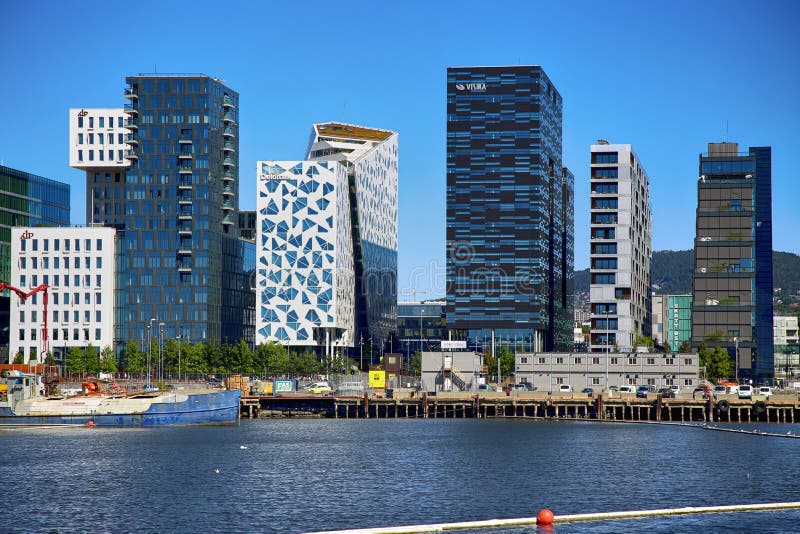 OSLO, NORWAY – AUGUST 17, 2016: View of The modern Oslo business district Bjorvika on Dronning Eufemias gate street. Modern architecture in in Oslo, Norway on August 17, 2016. OSLO, NORWAY – AUGUST 17, 2016: View of The modern Oslo business district Bjorvika on Dronning Eufemias gate street. Modern architecture in in Oslo, Norway on August 17, 2016.