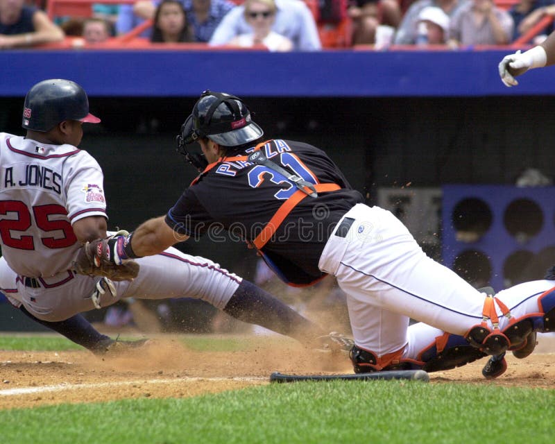 New York Mets catcher Mike Piazza appears to miss Andruw Jones of the Atlanta Braves as Jones touches home plate. (Image taken from color slide. ). New York Mets catcher Mike Piazza appears to miss Andruw Jones of the Atlanta Braves as Jones touches home plate. (Image taken from color slide. )