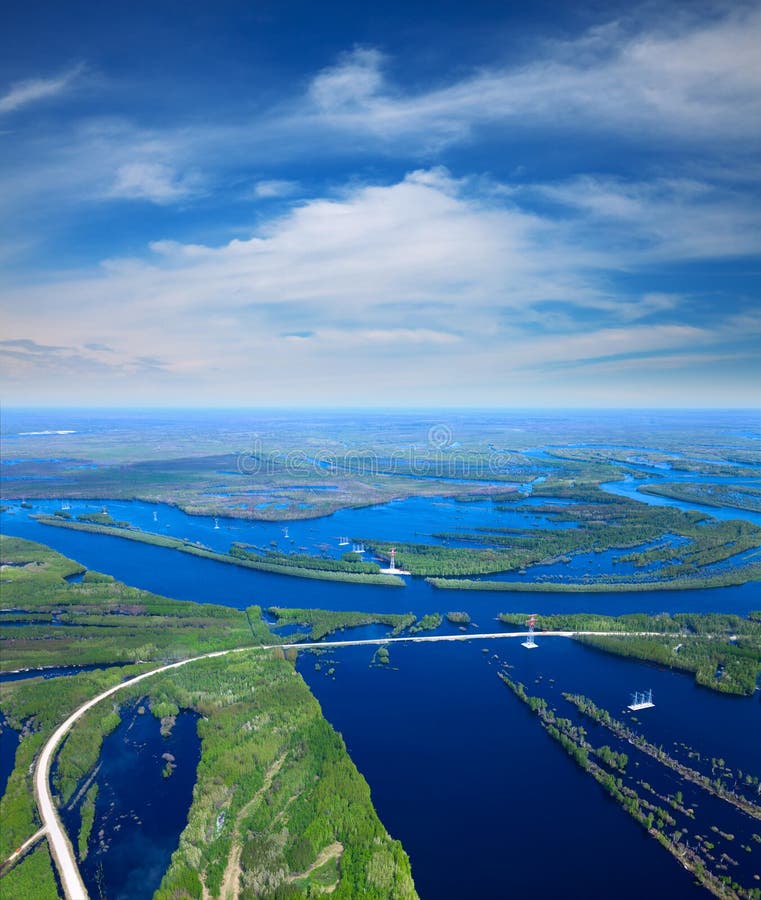 Aerial view flooded forest plains with country road and power lines. Aerial view flooded forest plains with country road and power lines.