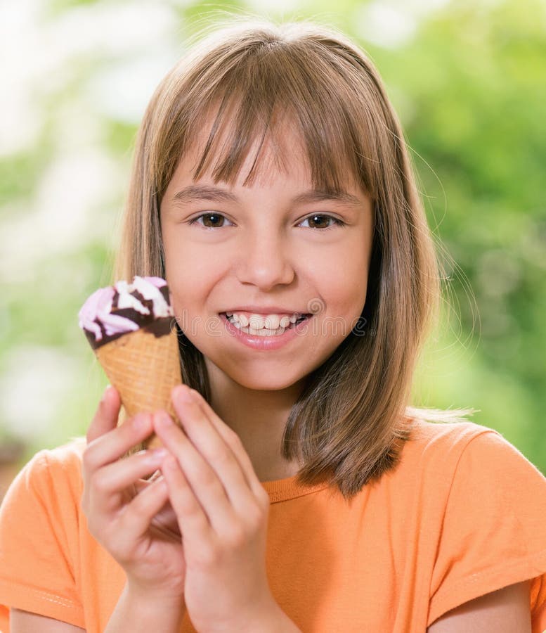 Outdoor portrait of happy girl 10-11 year old with ice cream cone. Outdoor portrait of happy girl 10-11 year old with ice cream cone