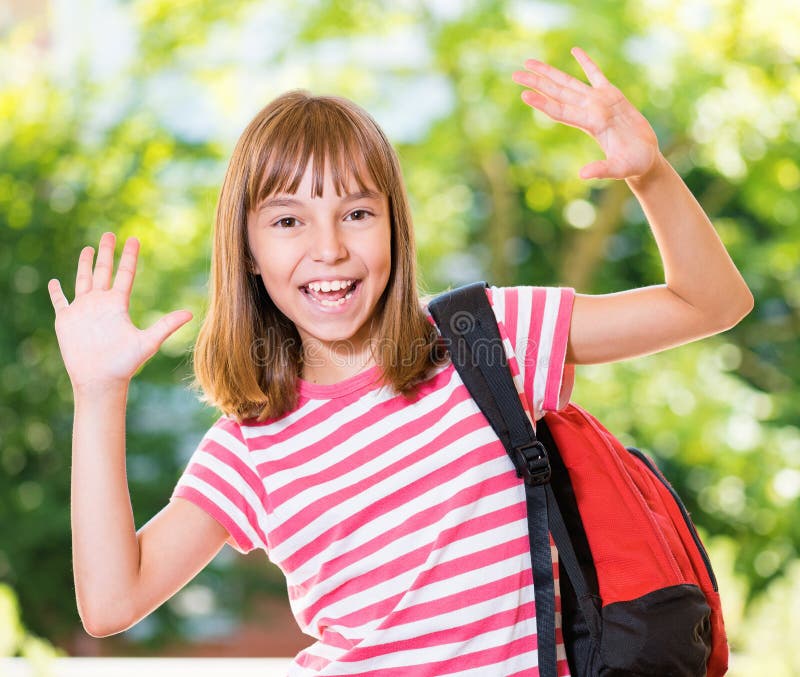 Cheerful cute girl 10-11 year old posing at park. Happy pupil with backpack. Cheerful cute girl 10-11 year old posing at park. Happy pupil with backpack.