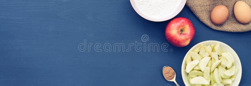 Banner with a set of ingredients for Apple pie on a grey wooden table. Copy space. Top view. Flat lay. Banner with a set of ingredients for Apple pie on a grey wooden table. Copy space. Top view. Flat lay