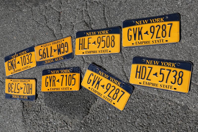 BROOKLYN, NEW YORK - AUGUST 13, 2017: Old car license plates at Brooklyn`s largest flea market in DUMBO. In the U.S., where each state issues plates, New York State has required plates since 1901. BROOKLYN, NEW YORK - AUGUST 13, 2017: Old car license plates at Brooklyn`s largest flea market in DUMBO. In the U.S., where each state issues plates, New York State has required plates since 1901