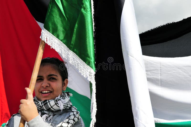 EREZ CROSSING-DEC 31:Palestinian woman carry Palestinian flag on Dec 31 2009.On April 2013, 132 (68.4%) of the 193 member states of the United Nations have recognized the State of Palestine. EREZ CROSSING-DEC 31:Palestinian woman carry Palestinian flag on Dec 31 2009.On April 2013, 132 (68.4%) of the 193 member states of the United Nations have recognized the State of Palestine.