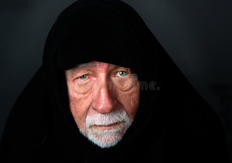 Elder Arab Sheik with a somber expression with a black headdress looking directly into the camera. Elder Arab Sheik with a somber expression with a black headdress looking directly into the camera