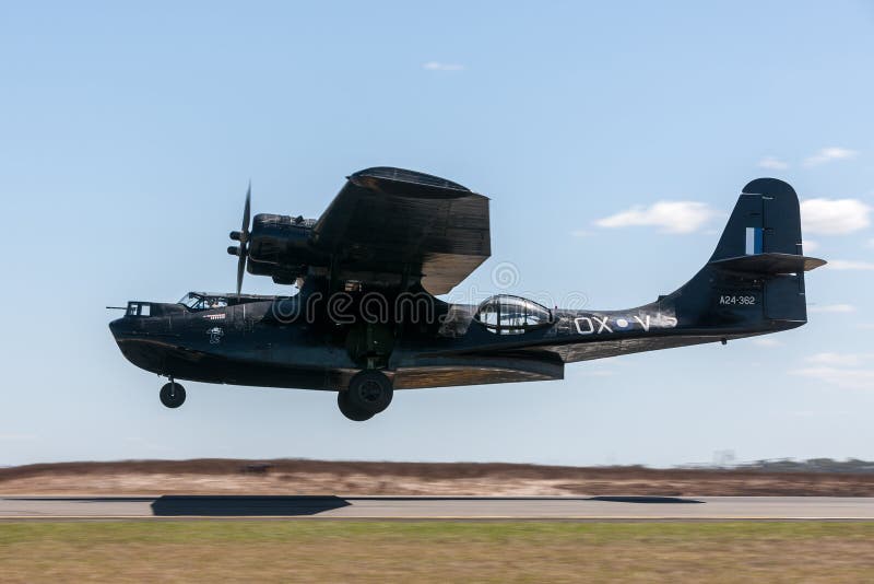 Avalon, Australia - March 1, 2013: Consolidated PBY Catalina Flying boat VH-PBZ wearing the famous Black Cats livery from the Royal Australian Air Force during World War II. Avalon, Australia - March 1, 2013: Consolidated PBY Catalina Flying boat VH-PBZ wearing the famous Black Cats livery from the Royal Australian Air Force during World War II.