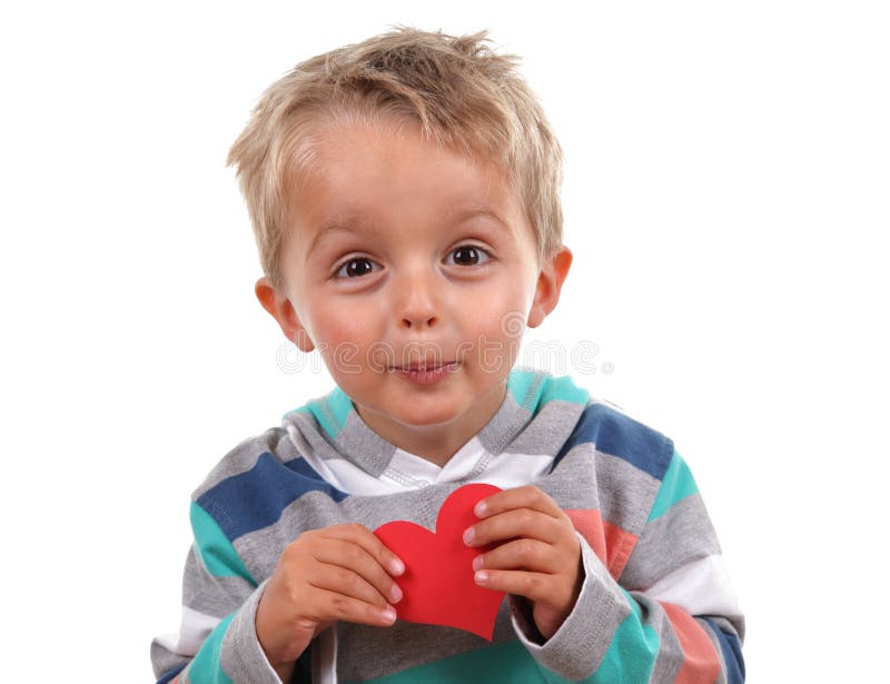 Little boy holding a valentines heart he has made. Little boy holding a valentines heart he has made