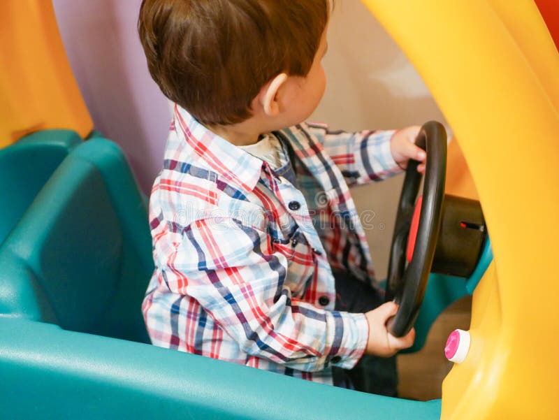 Child on a toy car. The car is yellow. child 0-1 year old. Child on a toy car. The car is yellow. child 0-1 year old.