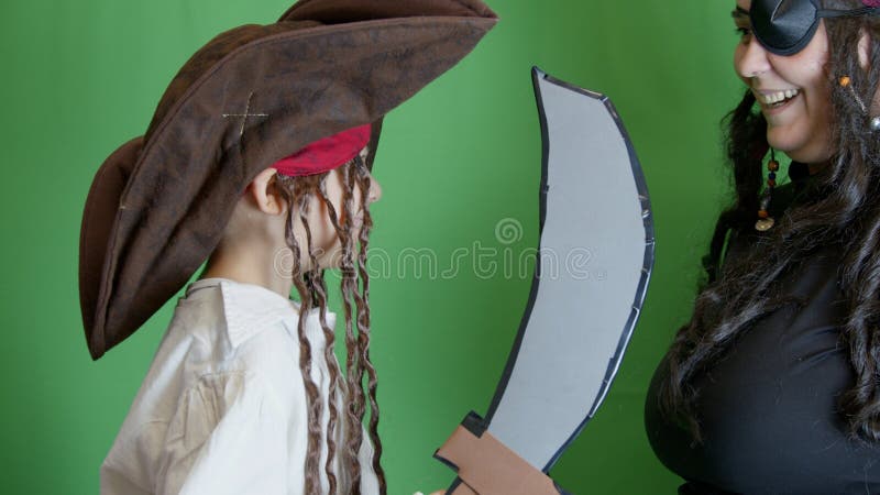 Pirate game. Mom and son having fight with fake cutlasses. Halloween activity. High quality photo. Pirate game. Mom and son having fight with fake cutlasses. Halloween activity. High quality photo