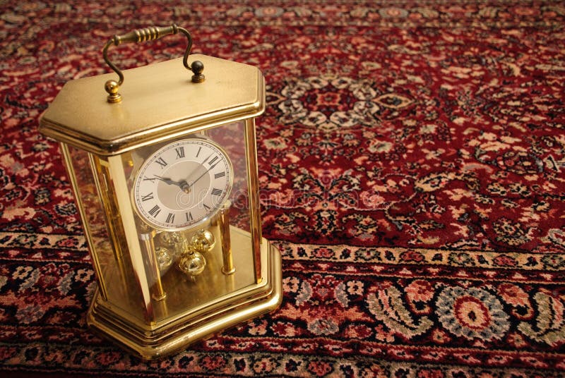 An antique clock with a bit of rust, styled like a gas lantern on a thick Persian rug. An antique clock with a bit of rust, styled like a gas lantern on a thick Persian rug