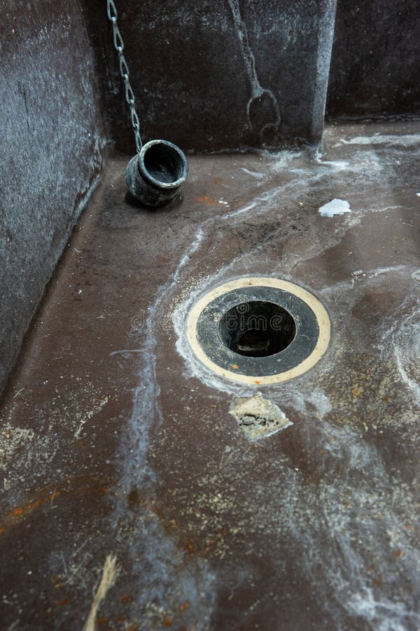 Old nasty and dirty water sink with drain hole and plug. Close up wide angle shot, no people. Old nasty and dirty water sink with drain hole and plug. Close up wide angle shot, no people.