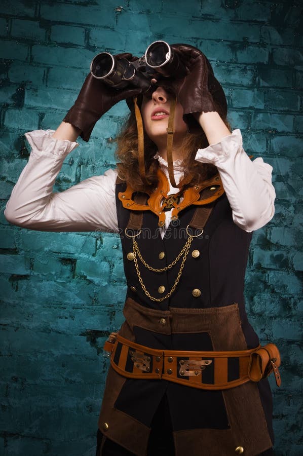 Steam punk girl with binocular in the hands. Steam punk girl with binocular in the hands