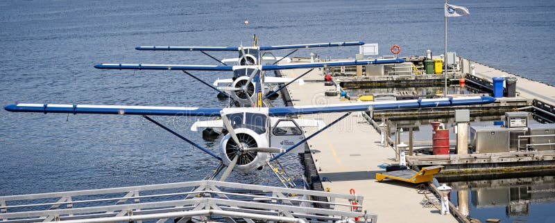 Panoramic close up of three Harbour Air seaplanes moored at floating terminal in Vancouver, British Columbia, Canada on 1 June 2023. Panoramic close up of three Harbour Air seaplanes moored at floating terminal in Vancouver, British Columbia, Canada on 1 June 2023