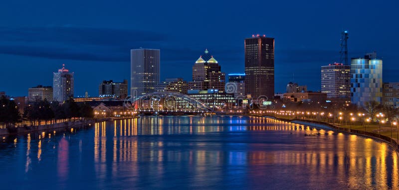 A nighttime panoramic view of downtown Rochester, New York on the Genesee River. A nighttime panoramic view of downtown Rochester, New York on the Genesee River