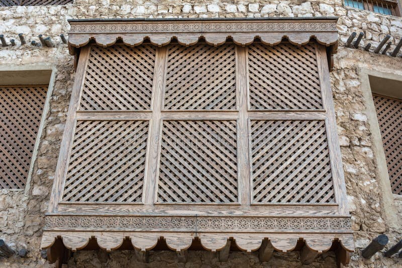 Traditional Arabic mashrabiya balcony enclosed with carved wood latticework in Doha, Qatar. Traditional Arabic mashrabiya balcony enclosed with carved wood latticework in Doha, Qatar