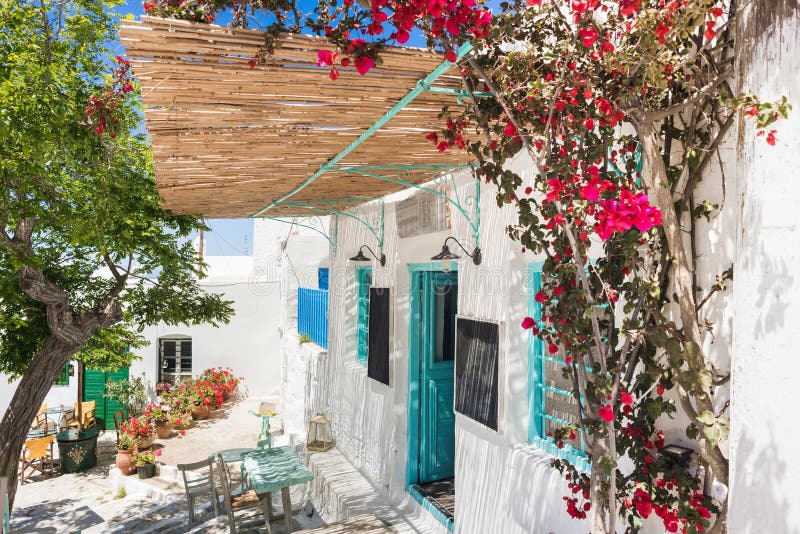 παραδοσιακός δρόμος με χαριτωμένα μπαρ καφετέριας στην ελλάδα. όμορφα πολύχρωμα ελληνικά σπίτια με λουλούδια στο νησί άμαργος στοκ φωτογραφία με δικαίωμα ελεύθερης χρήσης