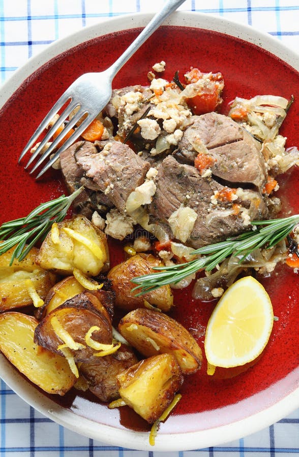 Traditional Greek kleftiko, an oven-baked lamb stew with mizithra cheese, olive oil, onion, carrot, garlic and herbs, served with lemon roast potatoes. Traditional Greek kleftiko, an oven-baked lamb stew with mizithra cheese, olive oil, onion, carrot, garlic and herbs, served with lemon roast potatoes