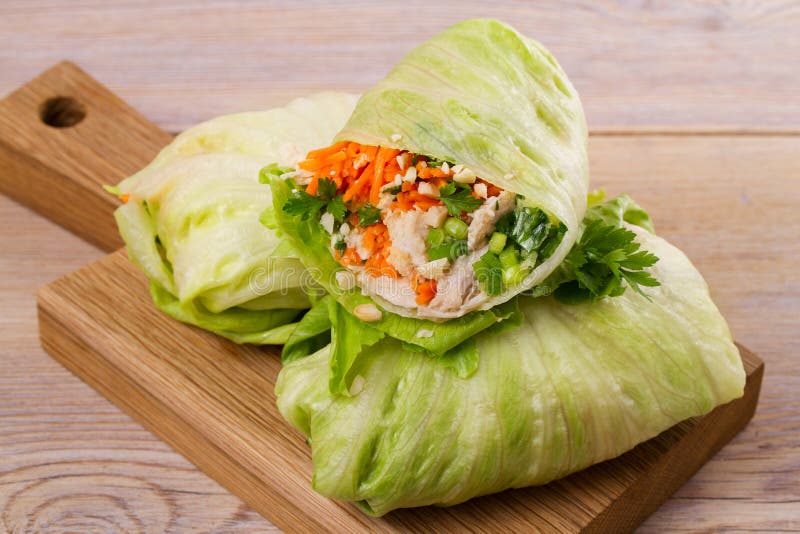 Lettuce wraps with chicken, carrot, peanuts and ginger-scallion oil, horizontal. Lettuce wraps with chicken, carrot, peanuts and ginger-scallion oil, horizontal