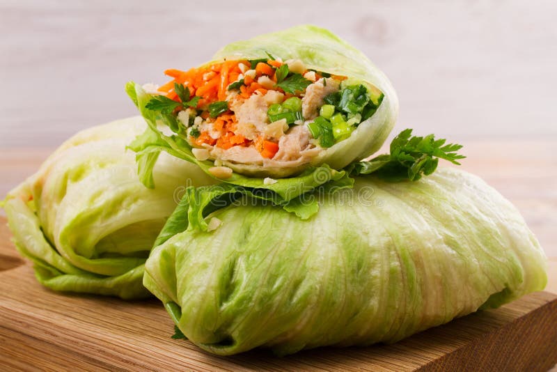 Lettuce wraps with chicken, carrot, peanuts and ginger-scallion oil, horizontal. Lettuce wraps with chicken, carrot, peanuts and ginger-scallion oil, horizontal