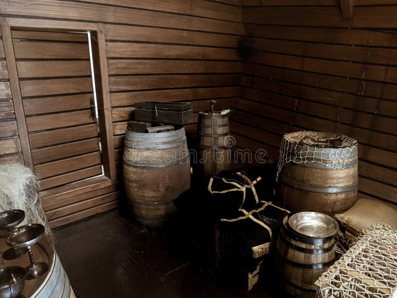 Interior cargo bay area of a wooden historical ship with barrels and ropes, Nao Victoria replica carrack of the ship of Magellan, Seville, Spain. Interior cargo bay area of a wooden historical ship with barrels and ropes, Nao Victoria replica carrack of the ship of Magellan, Seville, Spain